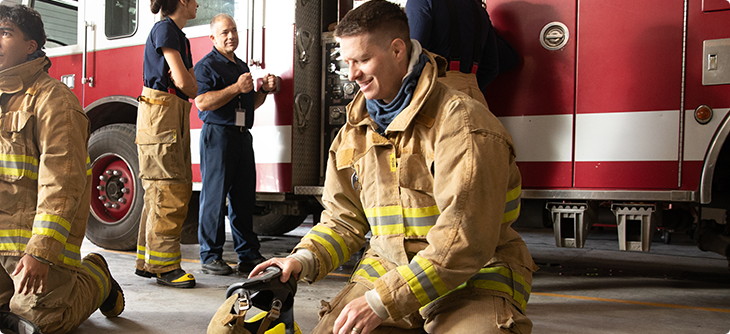 Zach in firefighter uniform.